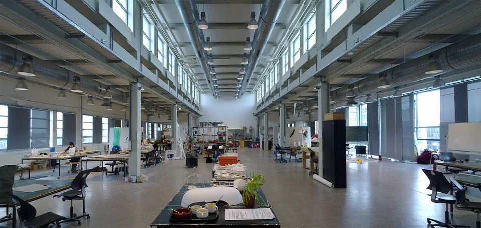 Spacious bright studio with long tables, models and tall windows