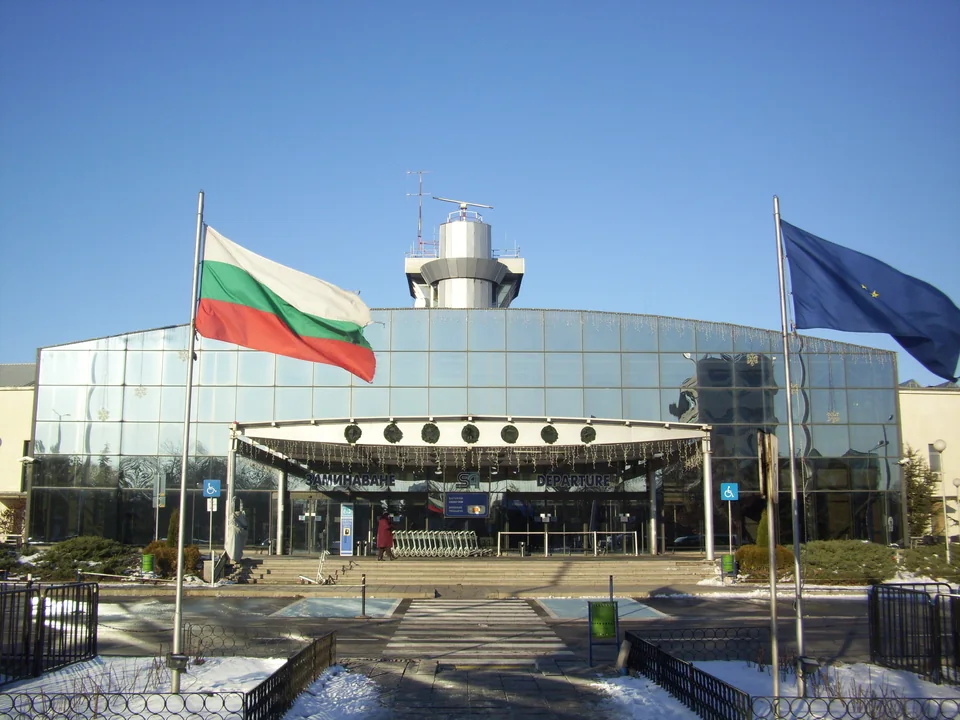 Glass terminal façade with the Bulgarian and EU flags at the entrance