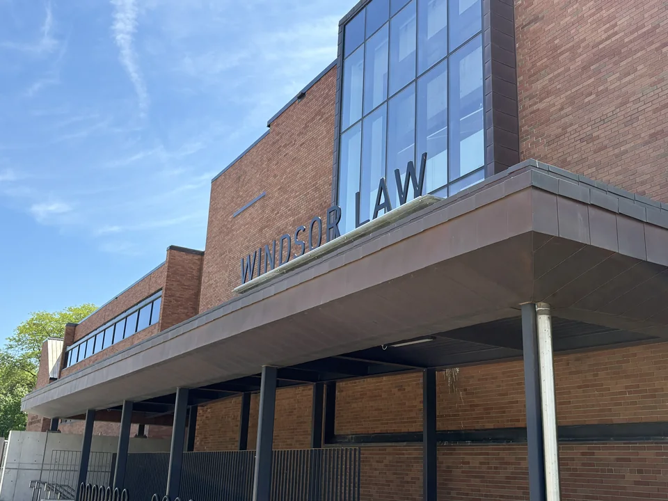 Brick façade with Windsor Law lettering above a canopy and a glazed bay