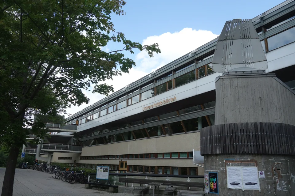 Long library building with a concrete tower and bicycles by the entrance